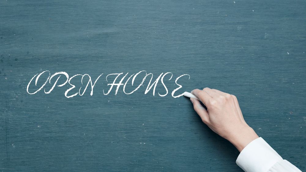 Green chalkboard with "OPEN HOUSE" written in chalk