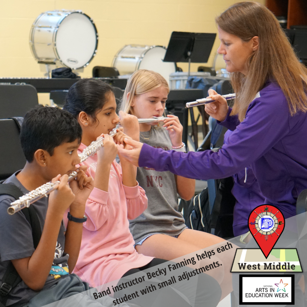 Teacher helps student make adjustments on flute