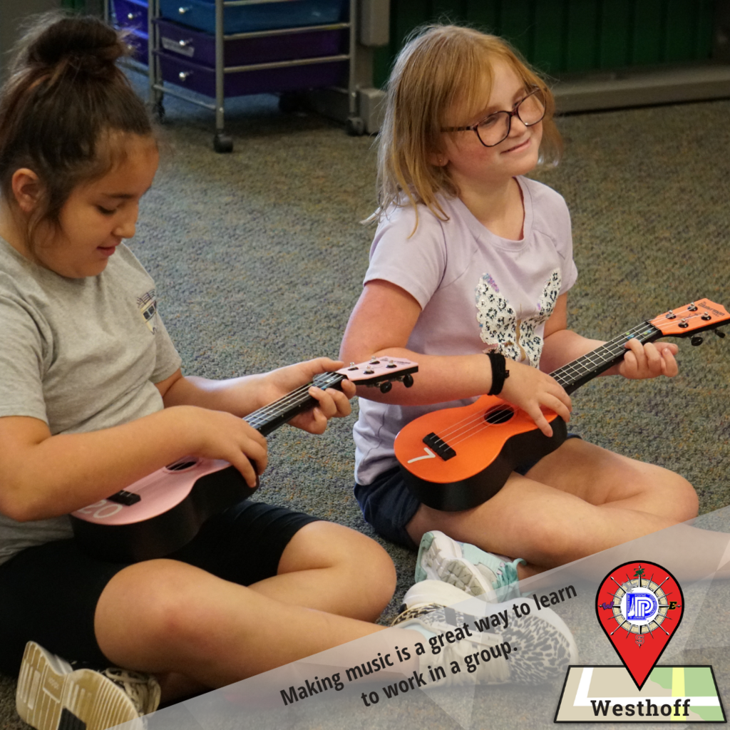 Working in pairs helps students practice ukulele