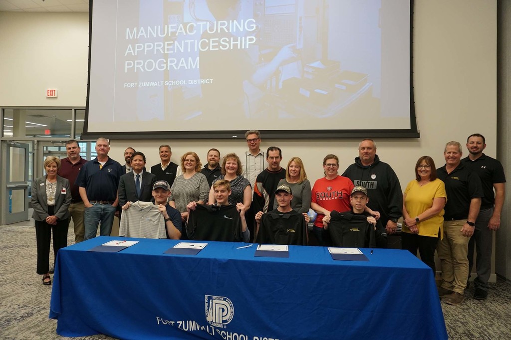 2022 apprenticeship signing day. Students in a group shot with teachers, employers, and parents 