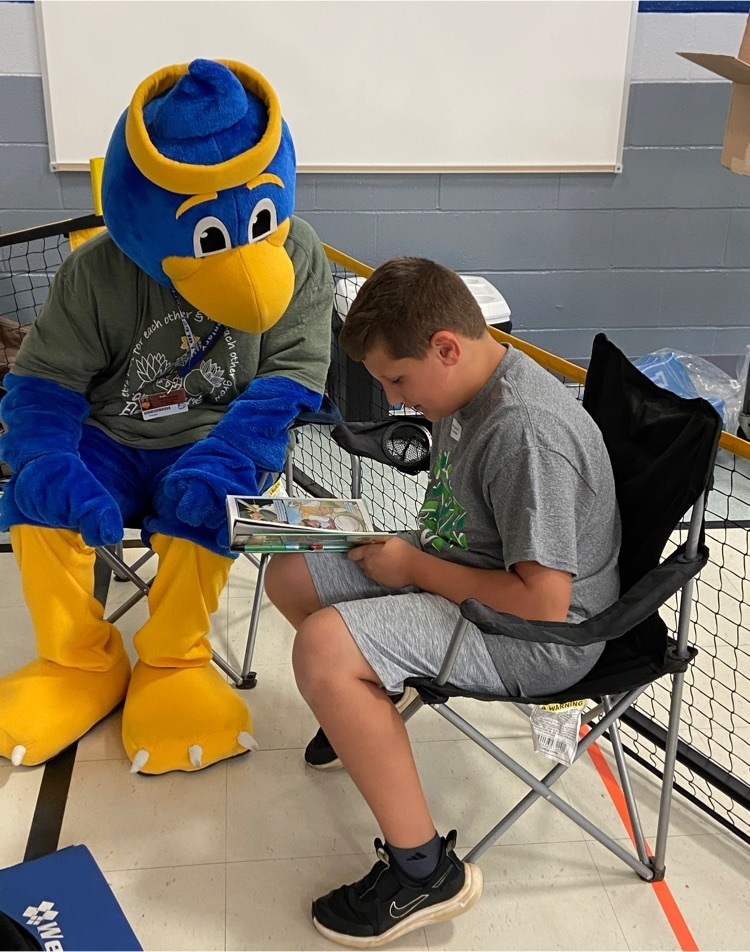 Student reading to FPE mascot  