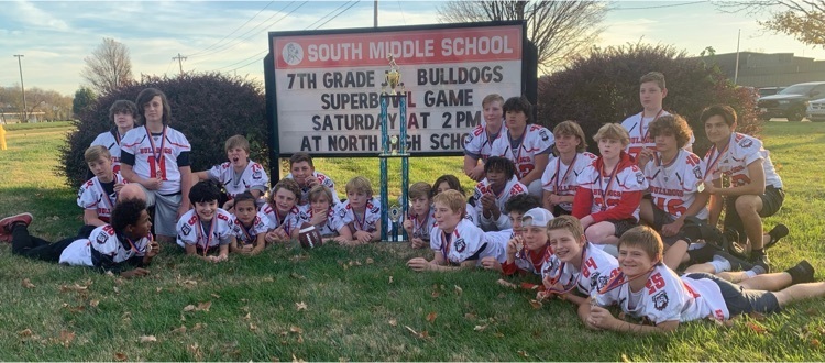 Junior Bulldogs in front of the marquee with trophy