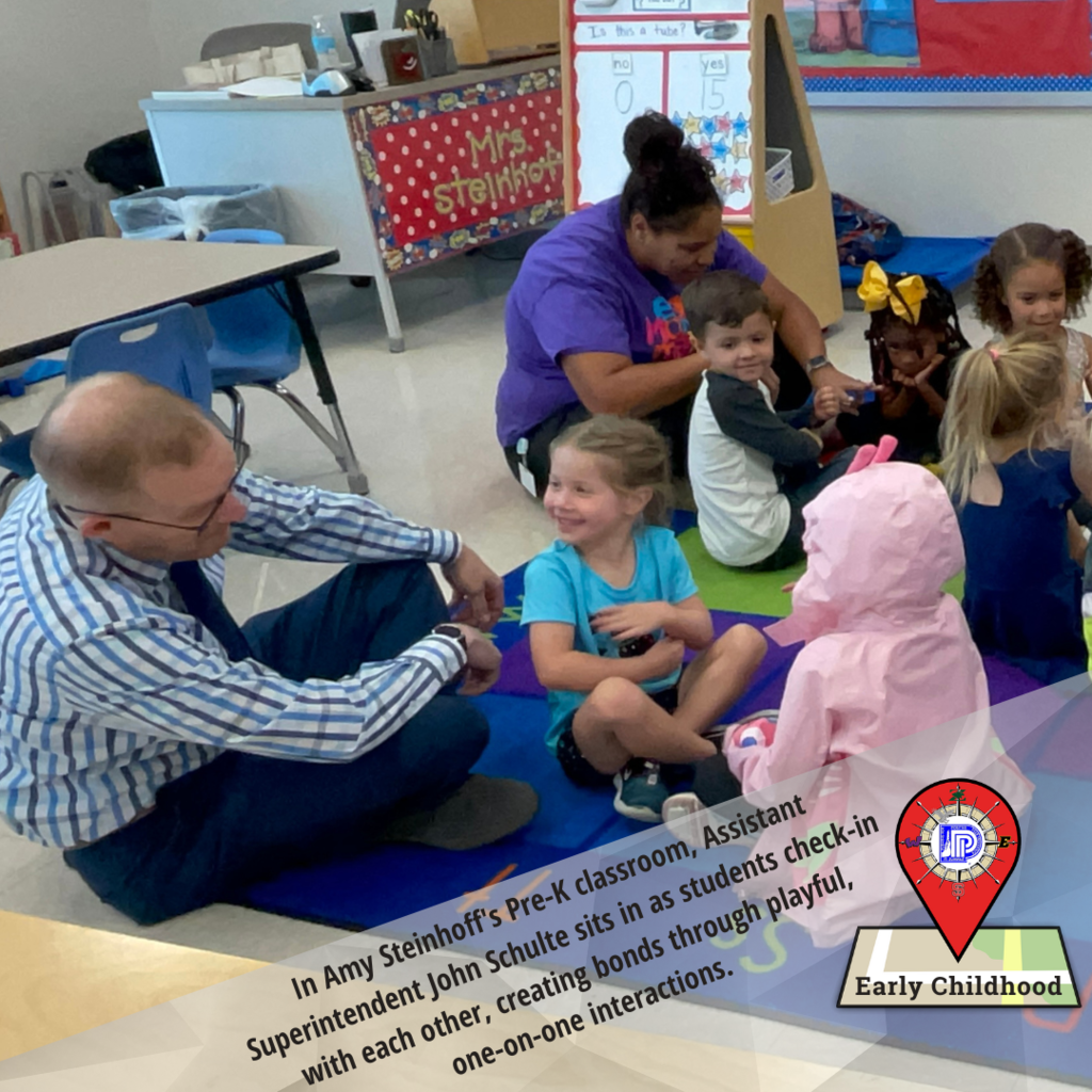 Assistant Superintendent visits with pre-K students in class
