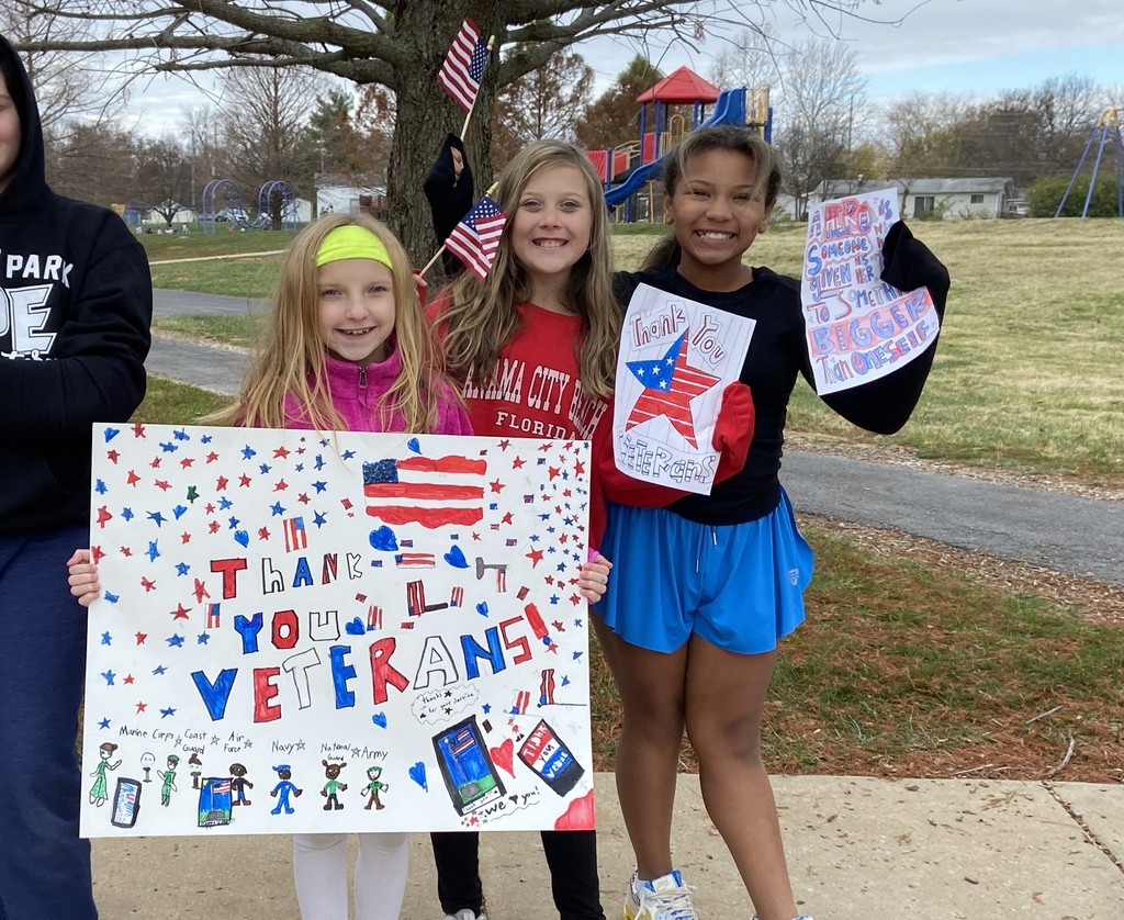 Students holding "Thank You Veterans" signs.