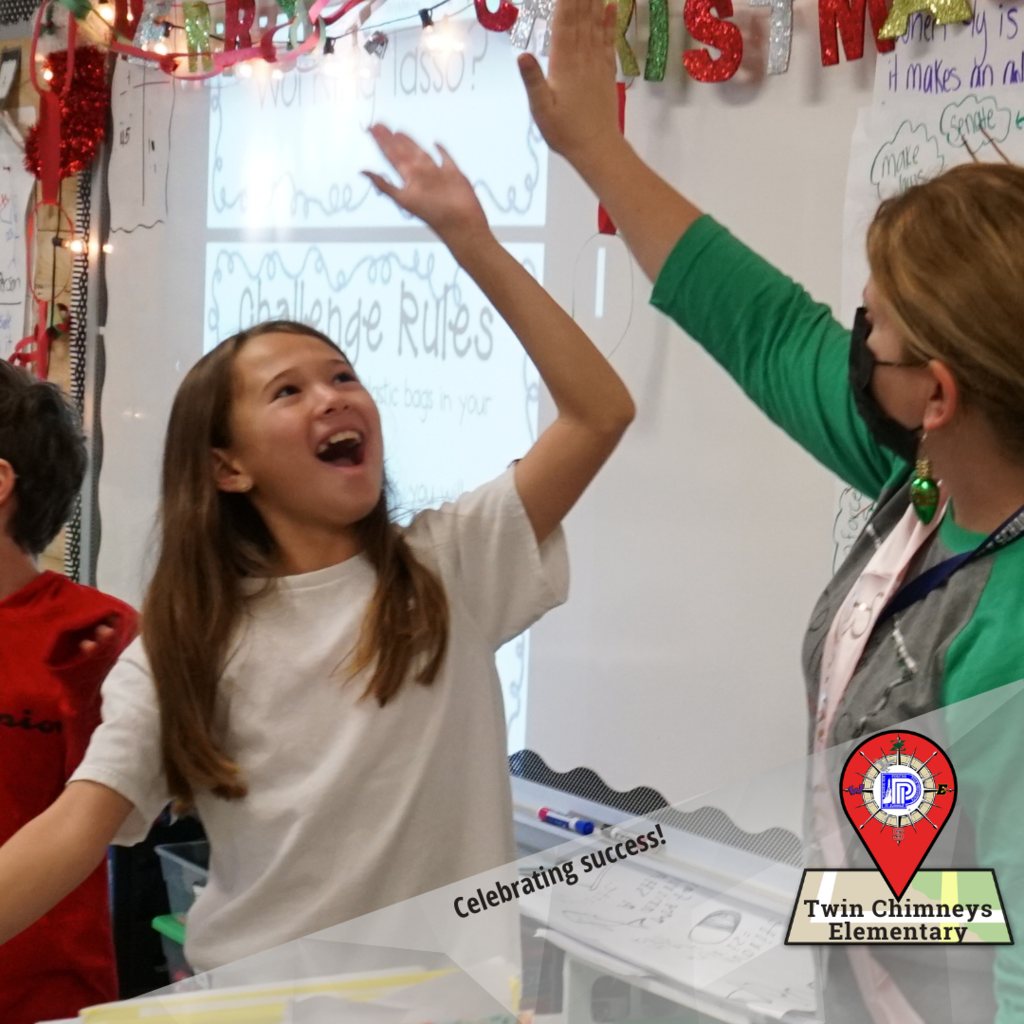 Student & Teacher High five celebrating success