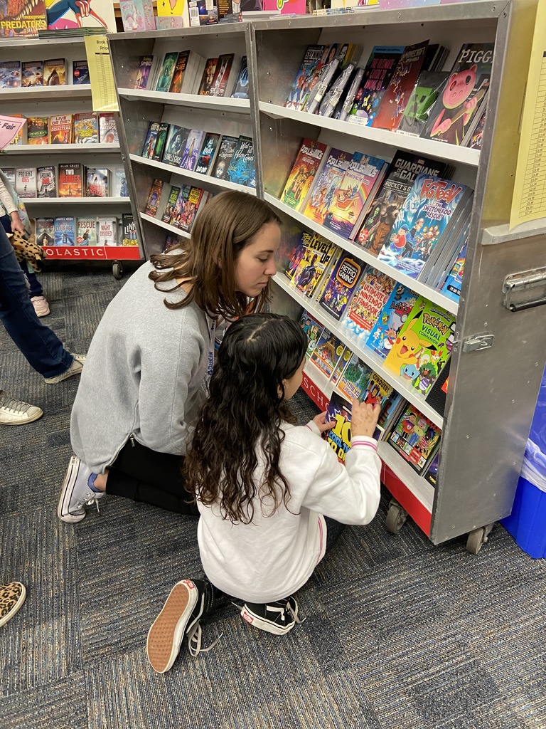 A book club member helps a teacher choose a good book for her classroom library.