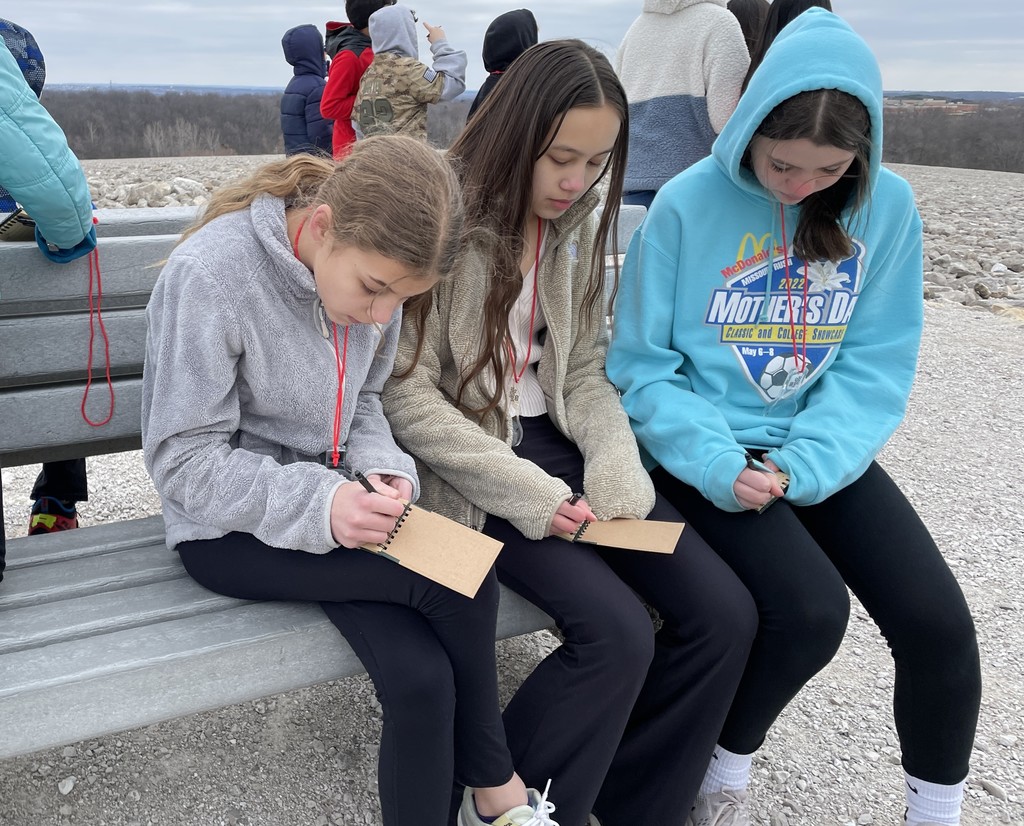 Students taking notes while on their field trip.