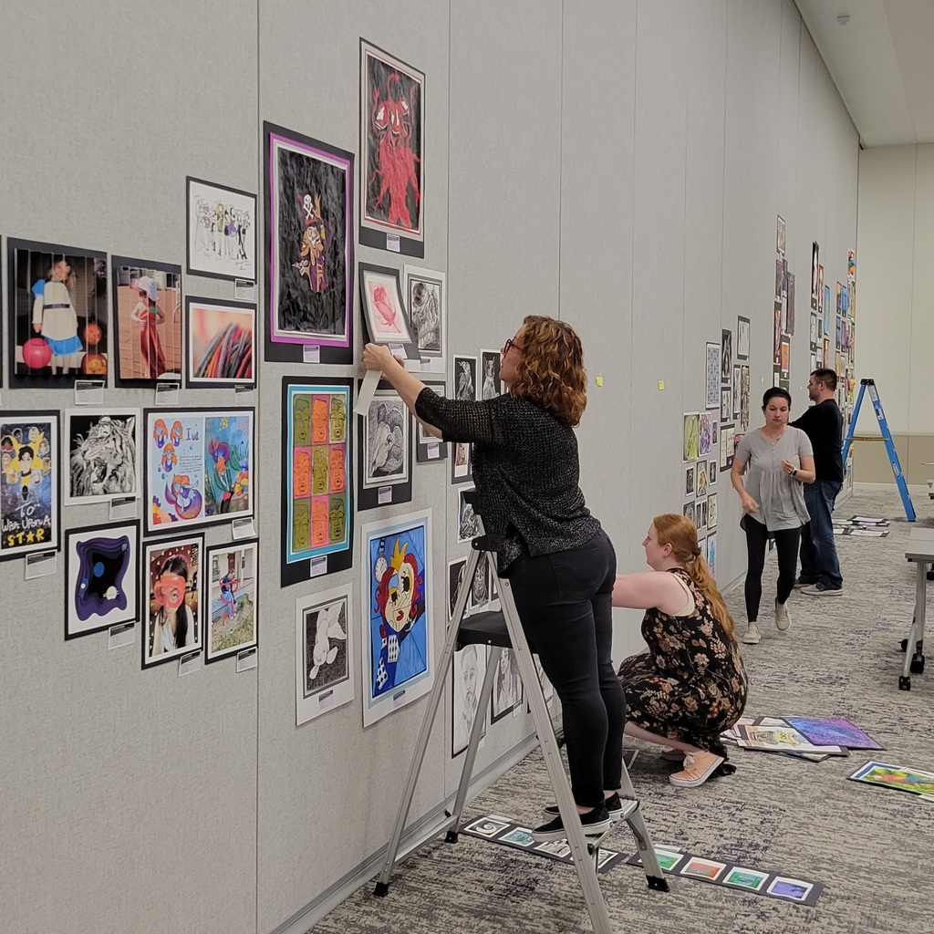 Teachers from across the district hang art high and low