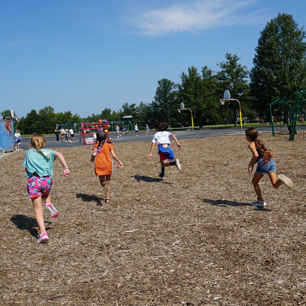 A group of girls races across the playground