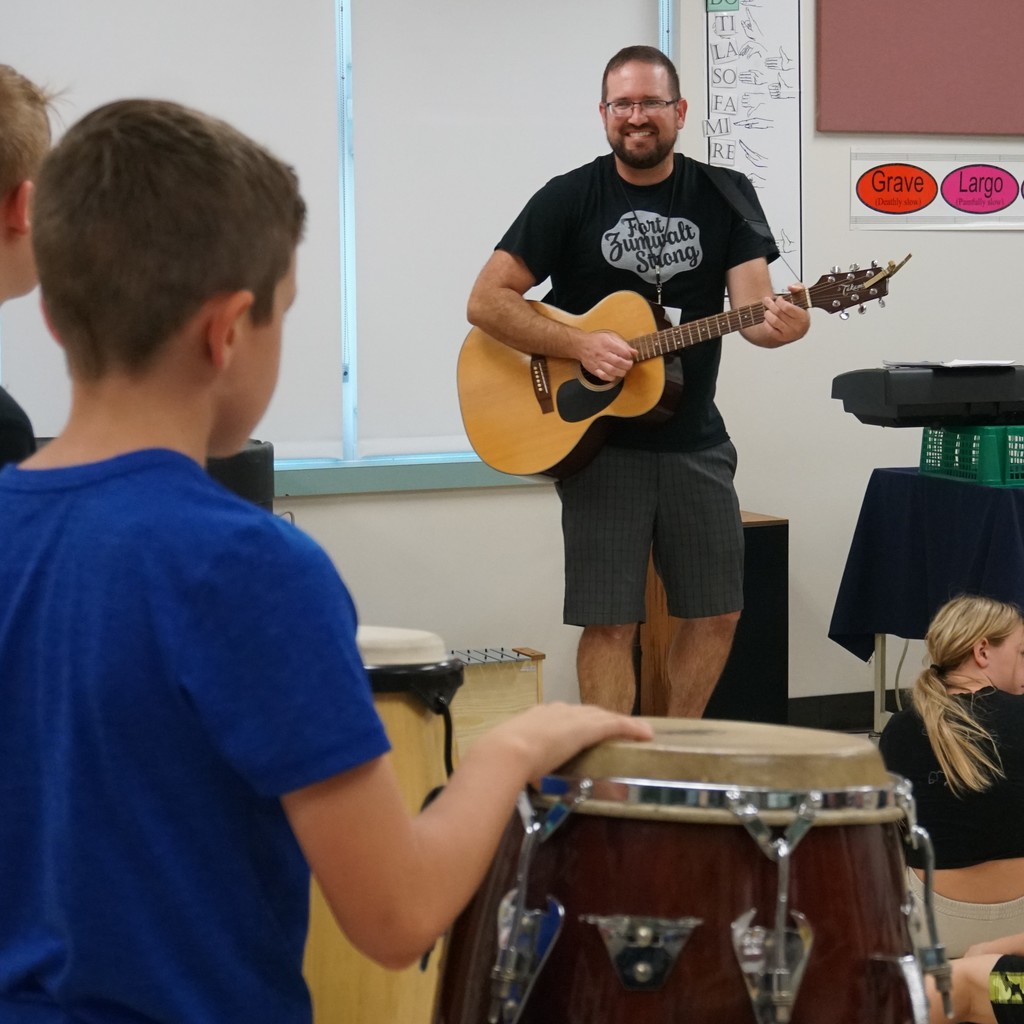 LCE music teacher Mr. Isreal playes guitar as he guides 4th graders through the world's percussion instruments.