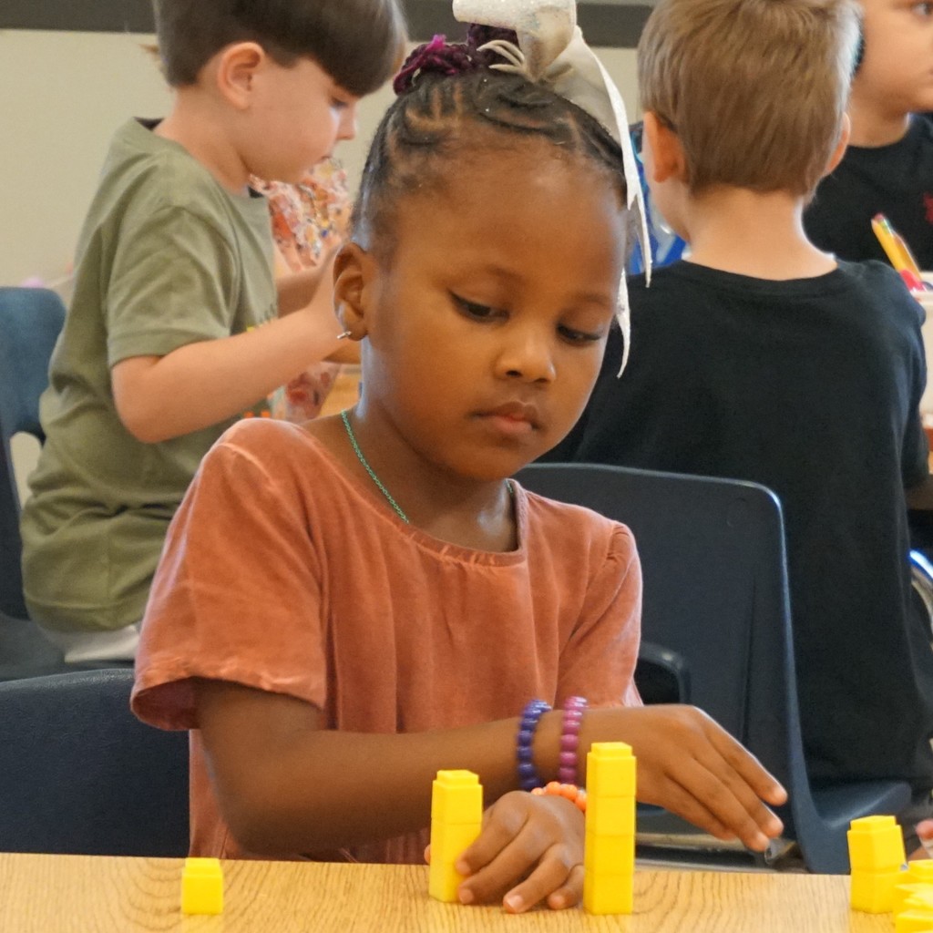 Kindergartener build numbers and an understanding of addition.